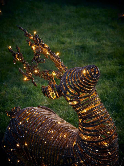 Soft Gold Faux Wicker Sit Down Lit Reindeer